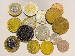 A picture of a pile of money in various currencies which is captioned comparing kids allowance